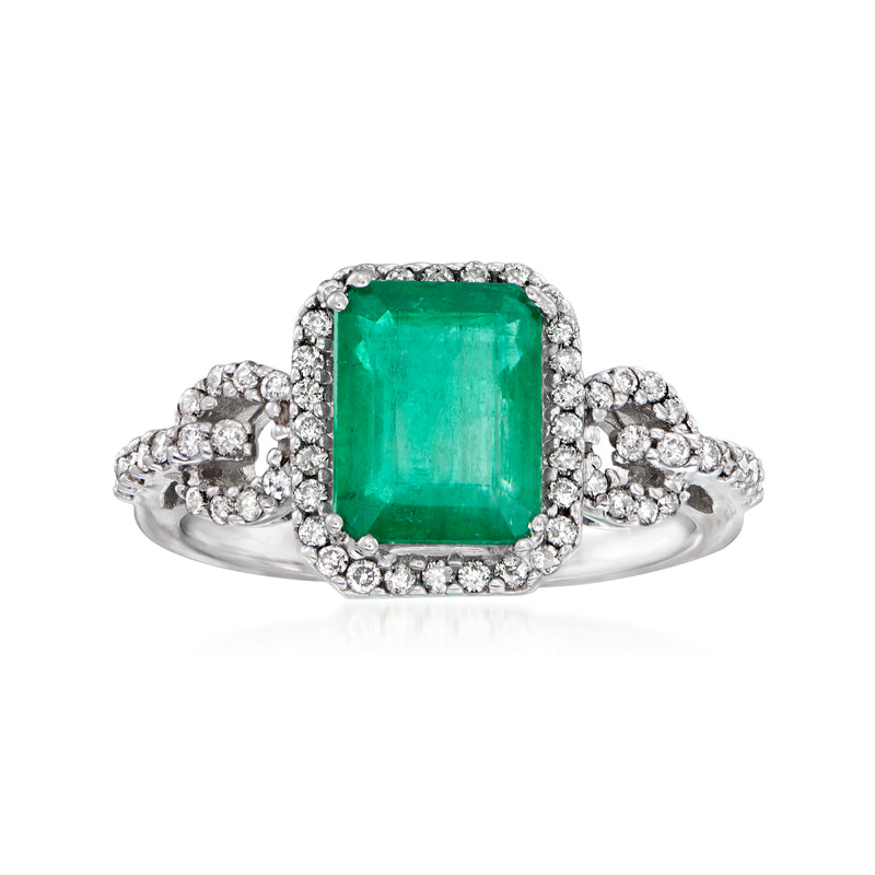 Emerald-cut green gemstone ring in white gold with diamond halo and side stones