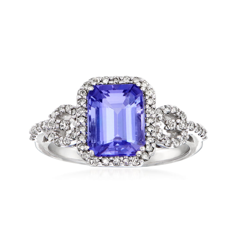 14kt white gold ring with square-cut blue-violet gemstone, diamond halo and side clusters.