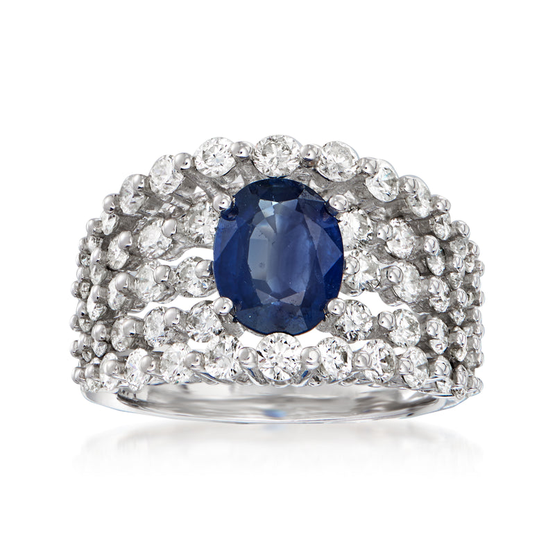 Oval sapphire center surrounded by round diamonds on white gold ring band