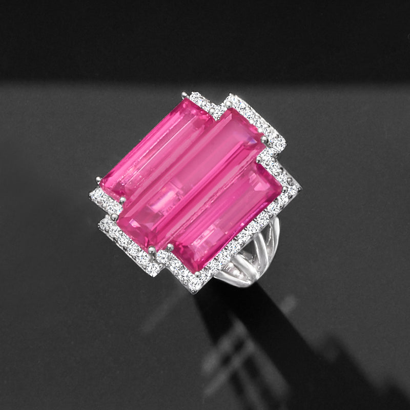 Sterling silver ring with square-cut halo framing a pink rectangular gemstone center