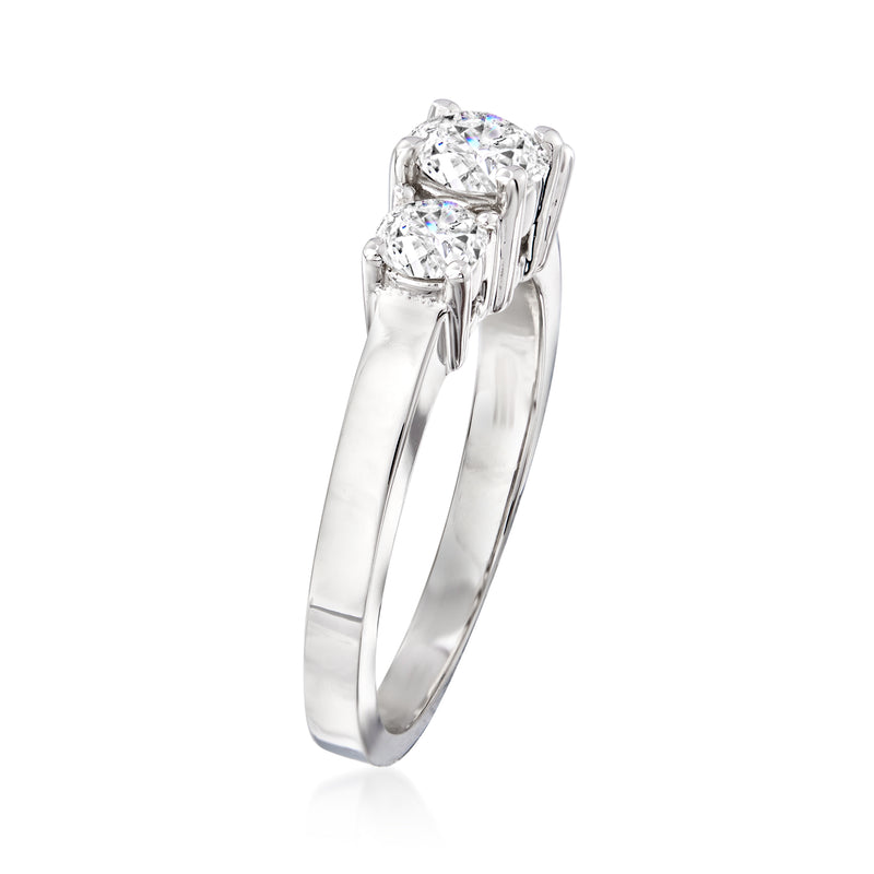 Three-stone diamond ring in 14kt white gold, side view of prong-set round stones