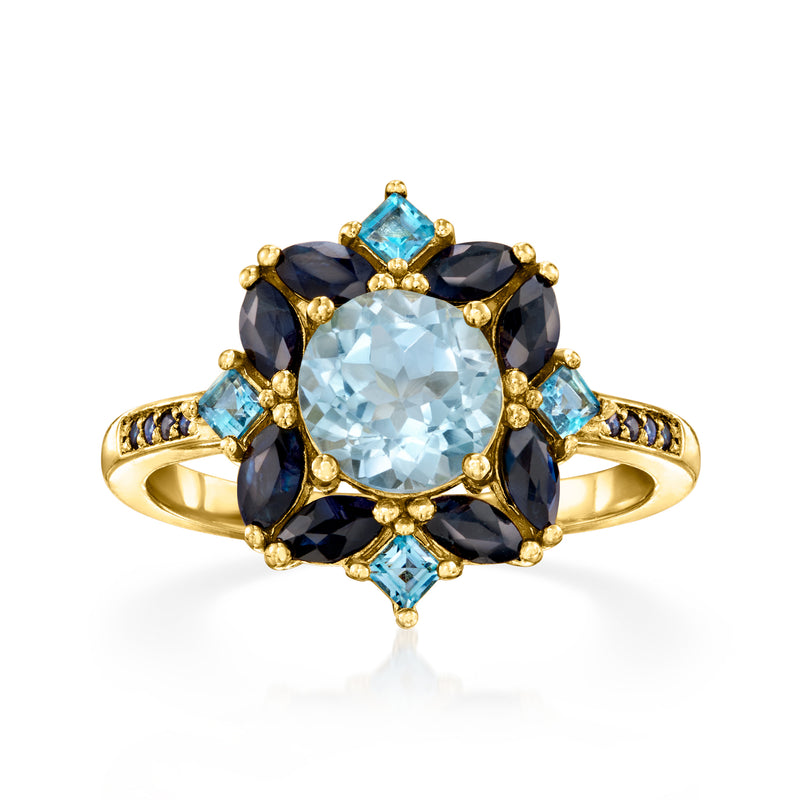 Gold over sterling ring with oval sky-blue center stone and dark blue side stones