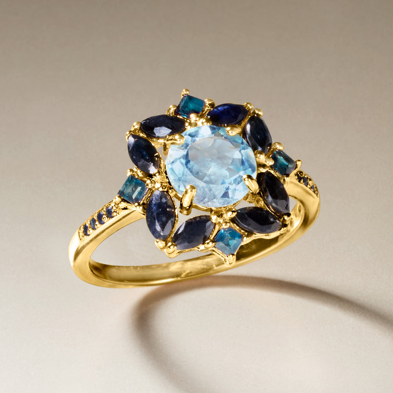 Gold over sterling ring with sky-blue oval center stone and dark navy marquise accents