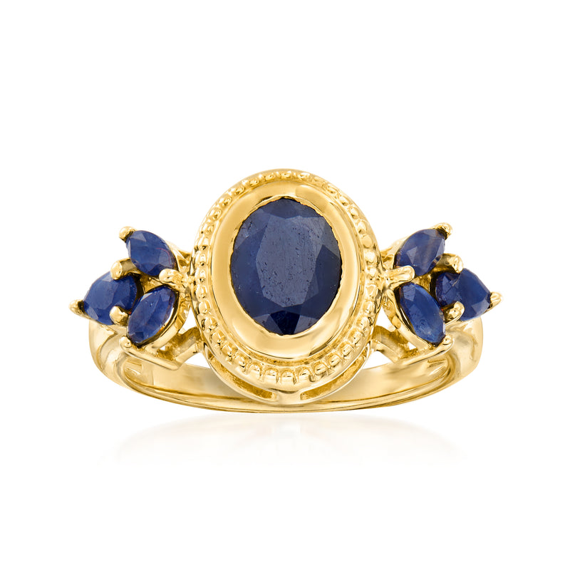 Gold over sterling sapphire ring with oval navy center stone and three blue accents
