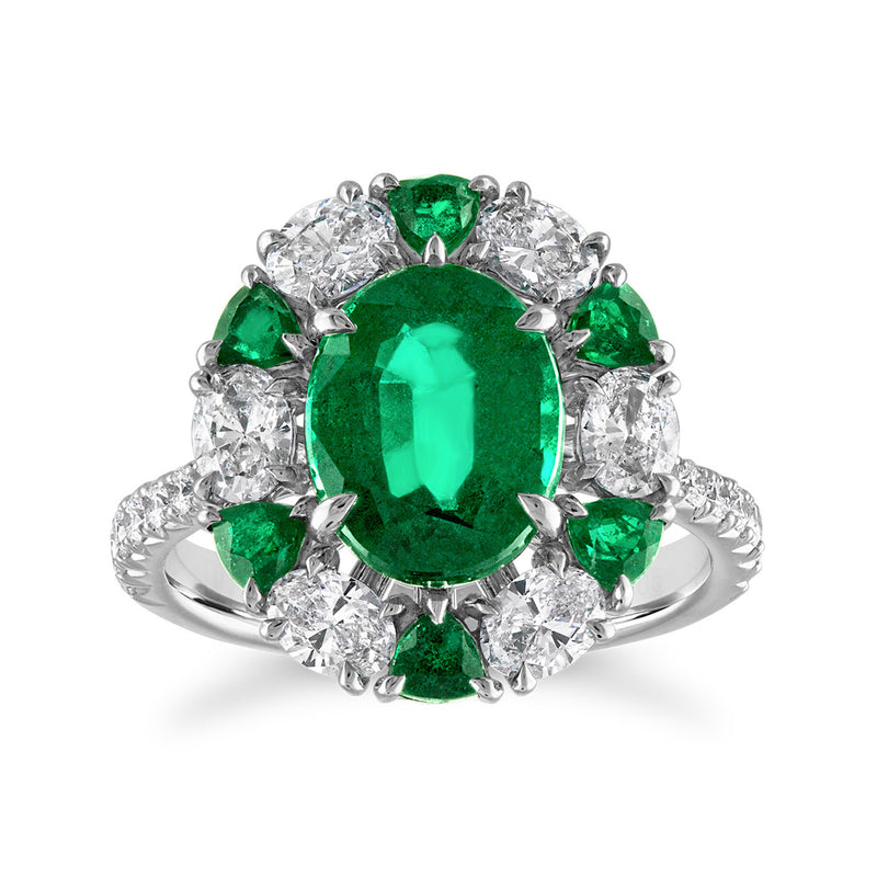 18kt white gold oval emerald center ring with round diamond halo and green accents