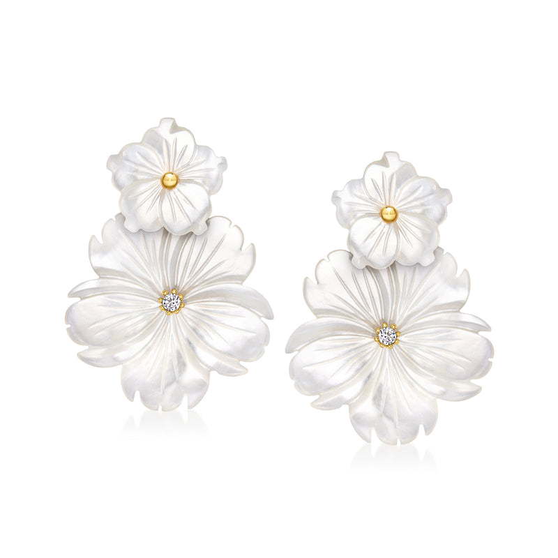 White flower drop earrings with stacked blossoms, gold posts, and crystal-like center stones