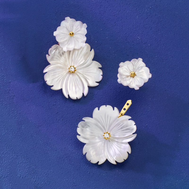 White mother-of-pearl flower earring set with removable drop pieces and gold center details
