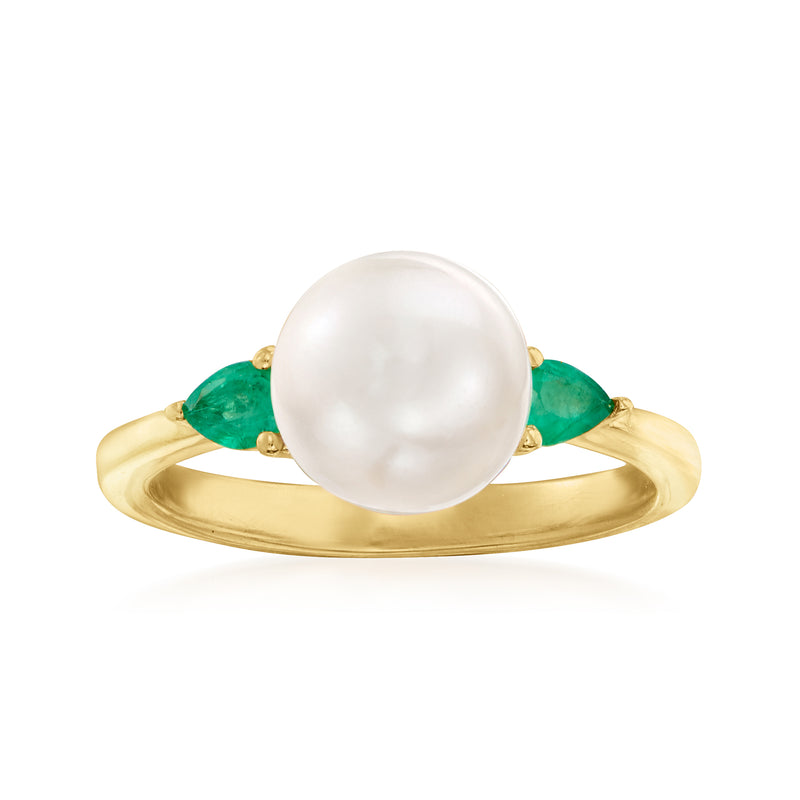 Gold ring with large white cultured pearl and emerald green side stones