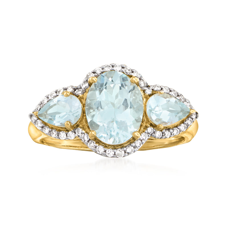 14kt yellow gold ring with oval aquamarine center, two side aquamarines, diamond accents