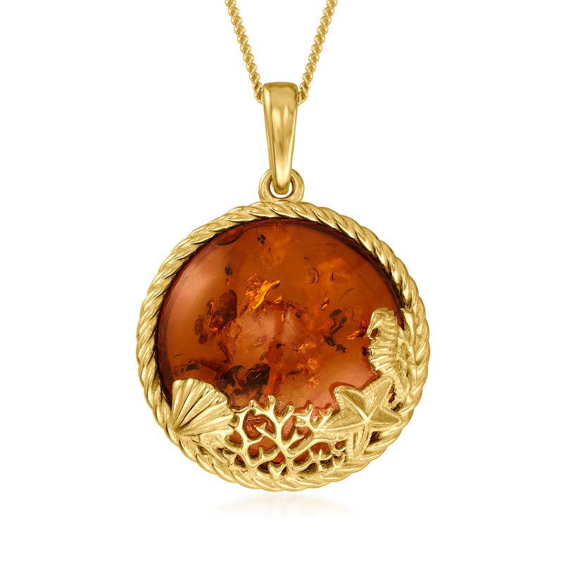 Gold-tone necklace with round amber pendant and embossed sea-life design