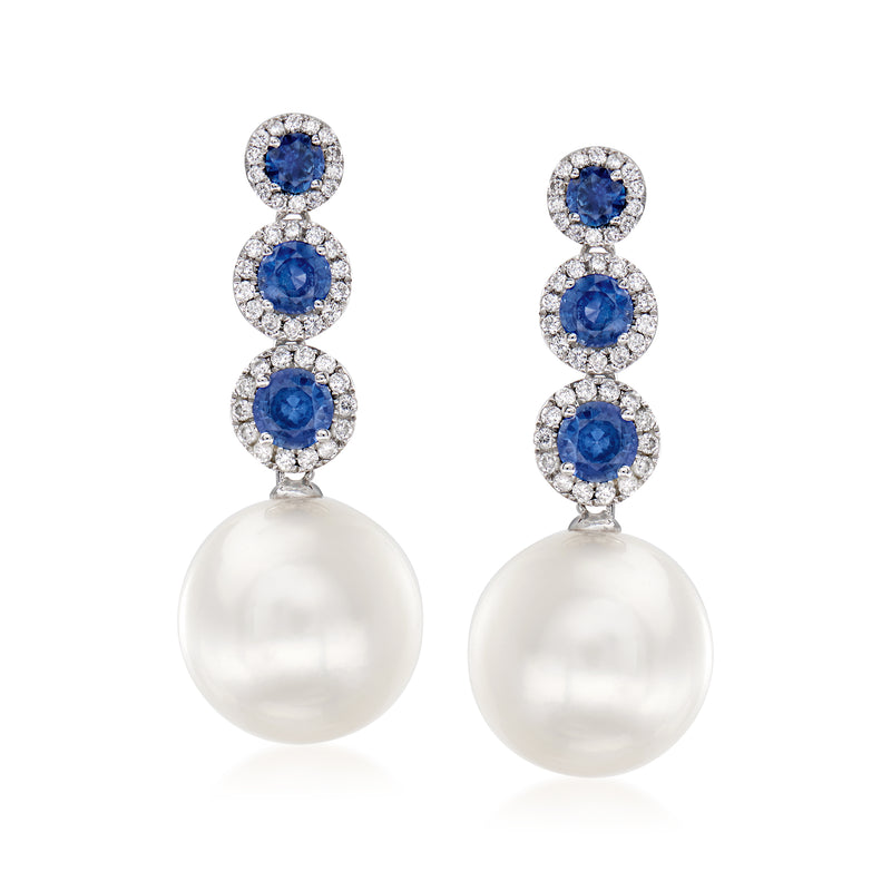 White gold drop earrings with blue sapphire and diamond halos, and white pearl drops