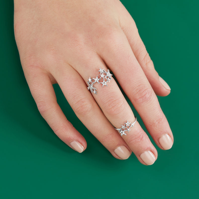 Star diamond ring set in sterling silver, two matching bands on hand