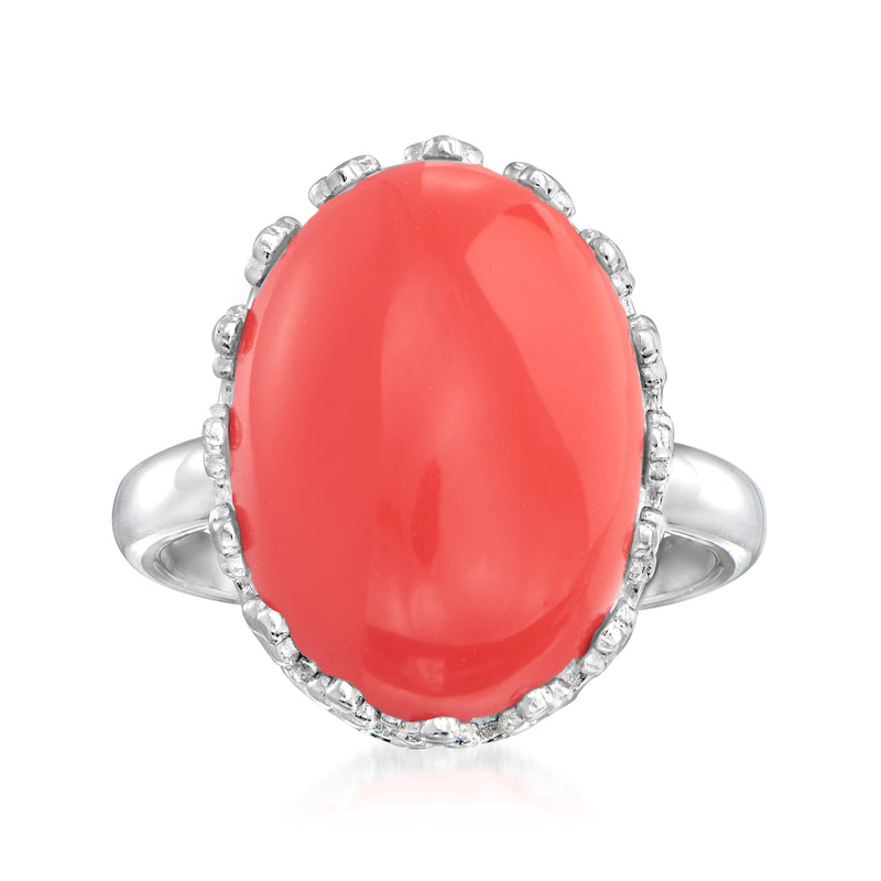 Sterling silver ring with oval coral-red centerpiece and textured halo setting