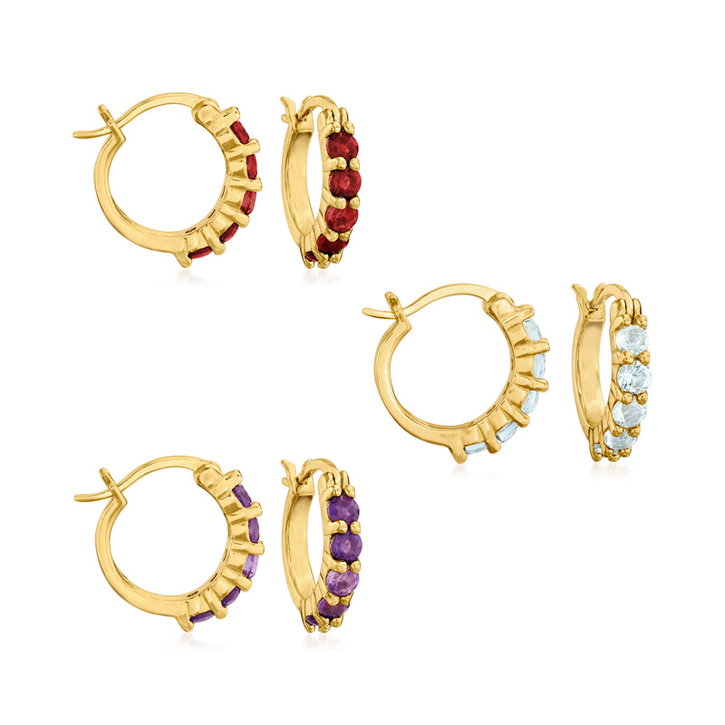 Three pairs huggie hoop earrings, gold-tone with amethyst, garnet, and blue topaz stones