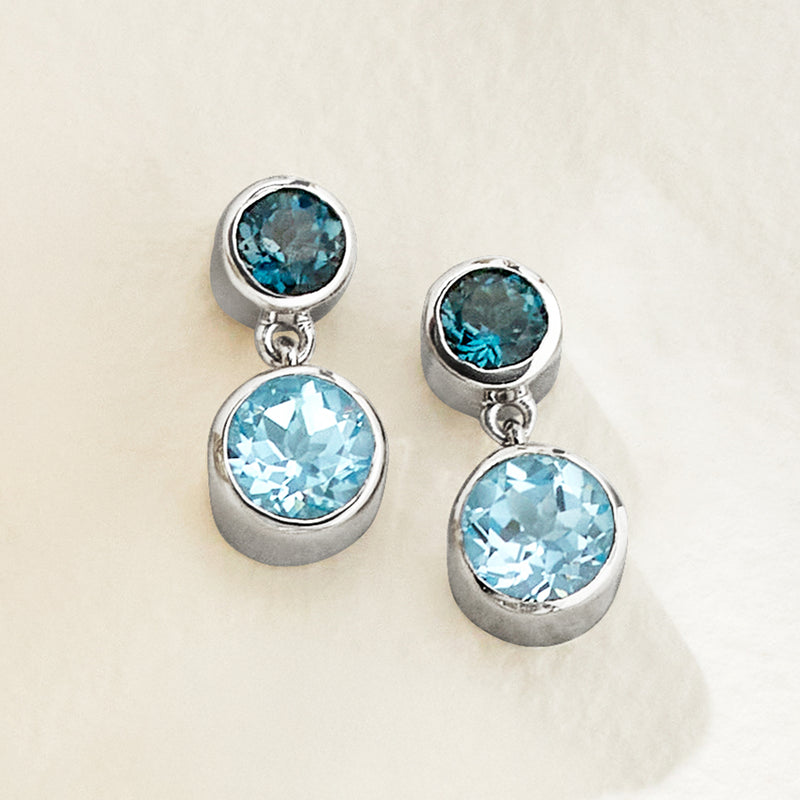 Sterling silver drop earrings with two-tone round blue topaz, faceted