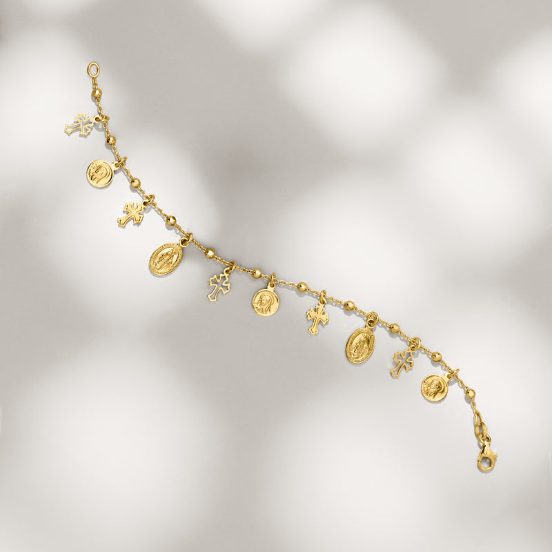 Gold-plated charm bracelet with dangling round medallion coins and cross charms