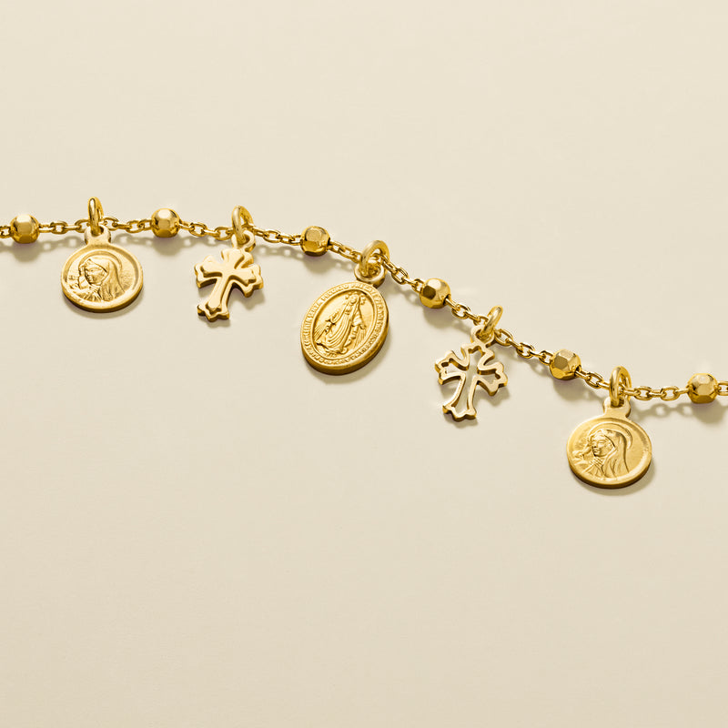 Gold-plated bracelet with round medallion coins, cross charms, and chain links
