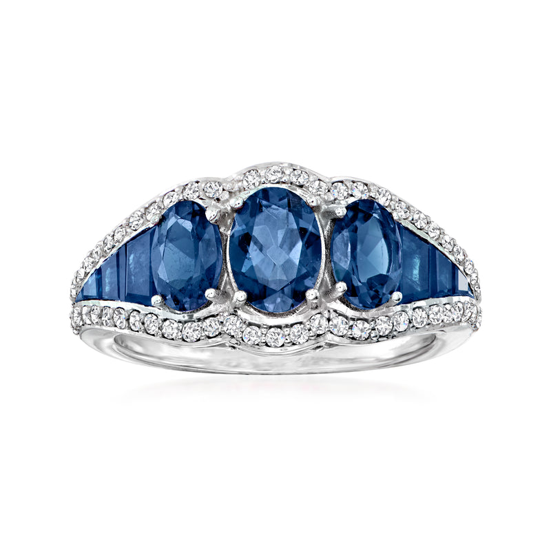 Sapphire three-stone ring in white gold with three blue oval stones and diamond accents