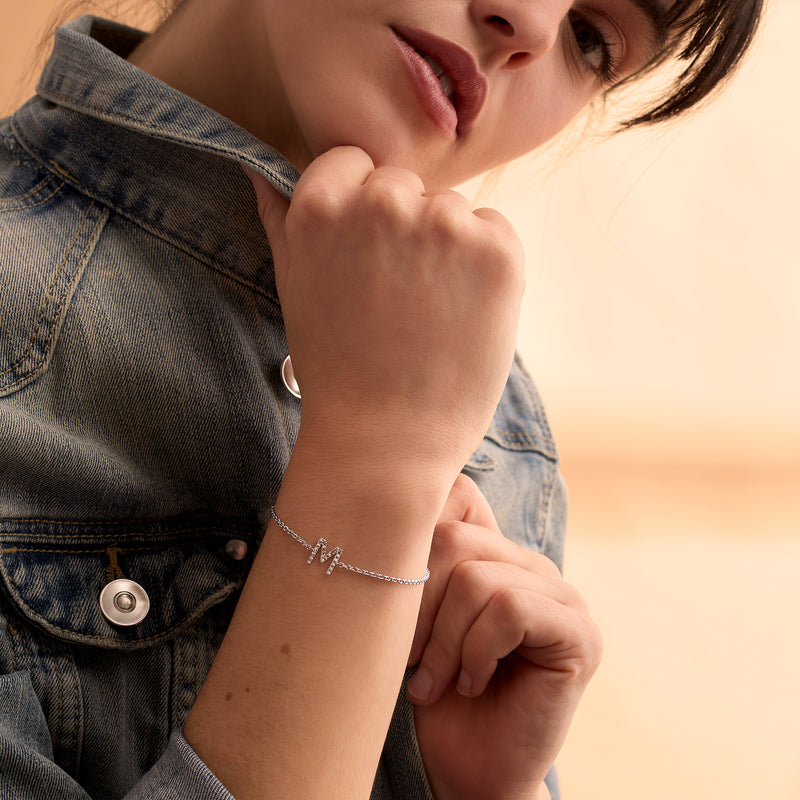 Sterling silver diamond initial bracelet worn on wrist
