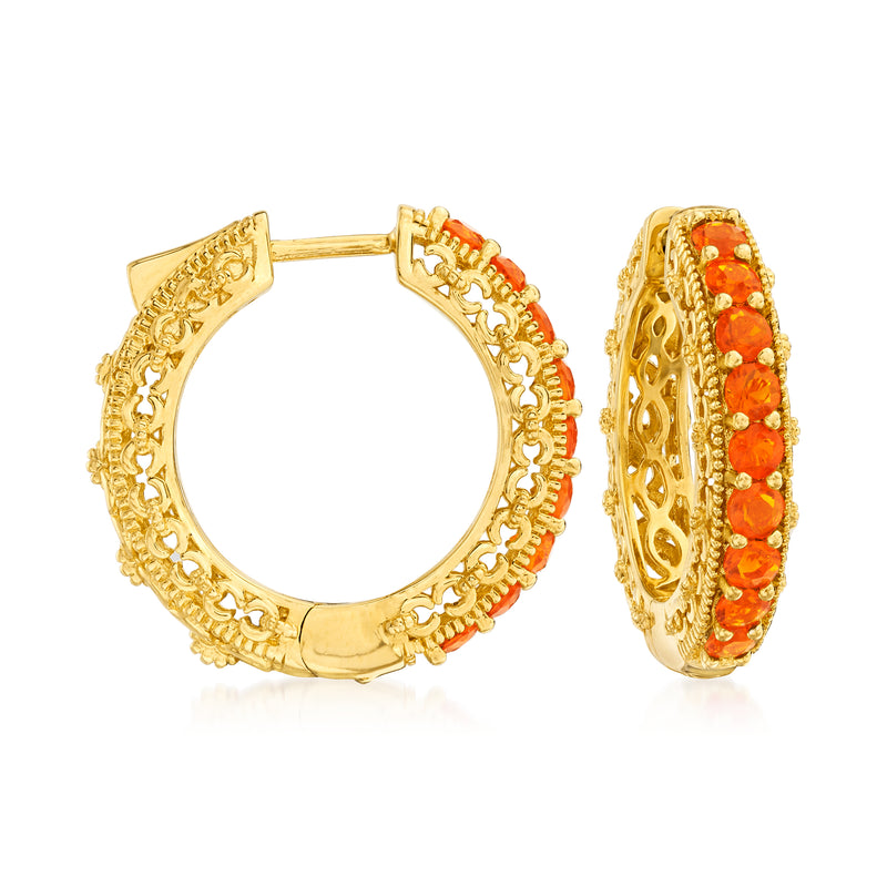 Gold hoop earrings with orange fire opal stones, ornate bezel setting.