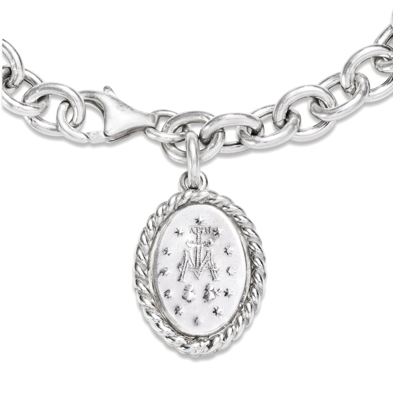 Oval Miraculous Medal charm on sterling silver link bracelet, close-up