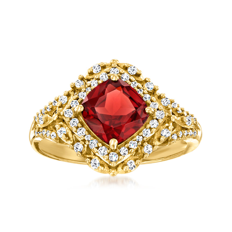 14kt yellow gold ring with pear-shaped garnet center and diamond halo accents