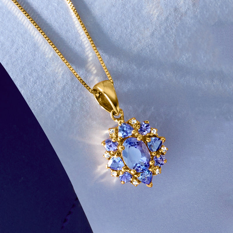 Tanzanite pendant on 14kt yellow gold chain with blue oval stone and diamond cluster