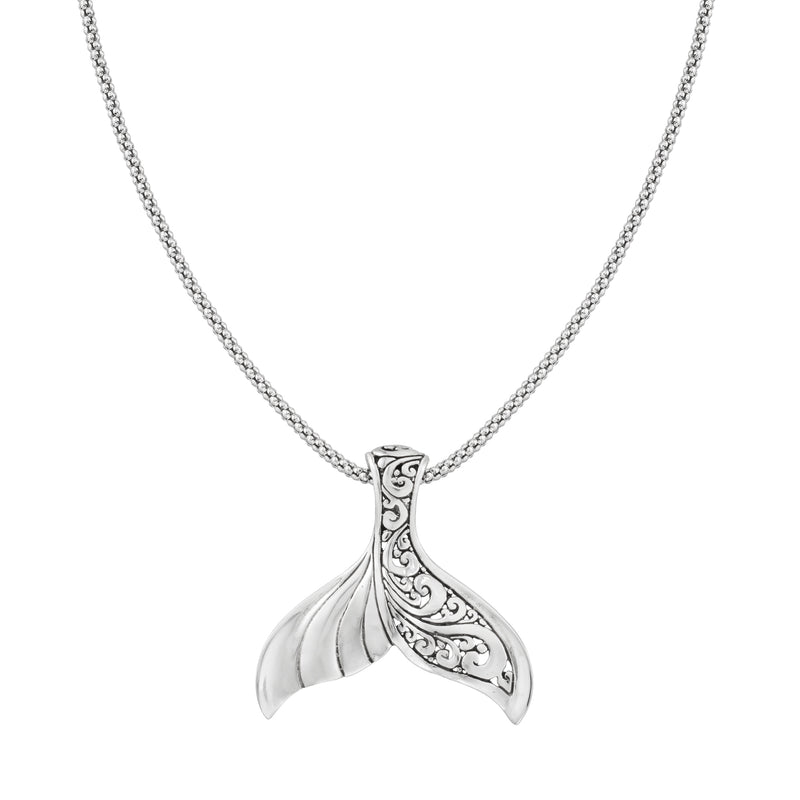 Sterling silver whale tail pendant necklace with ornate swirl engraving, simple chain.
