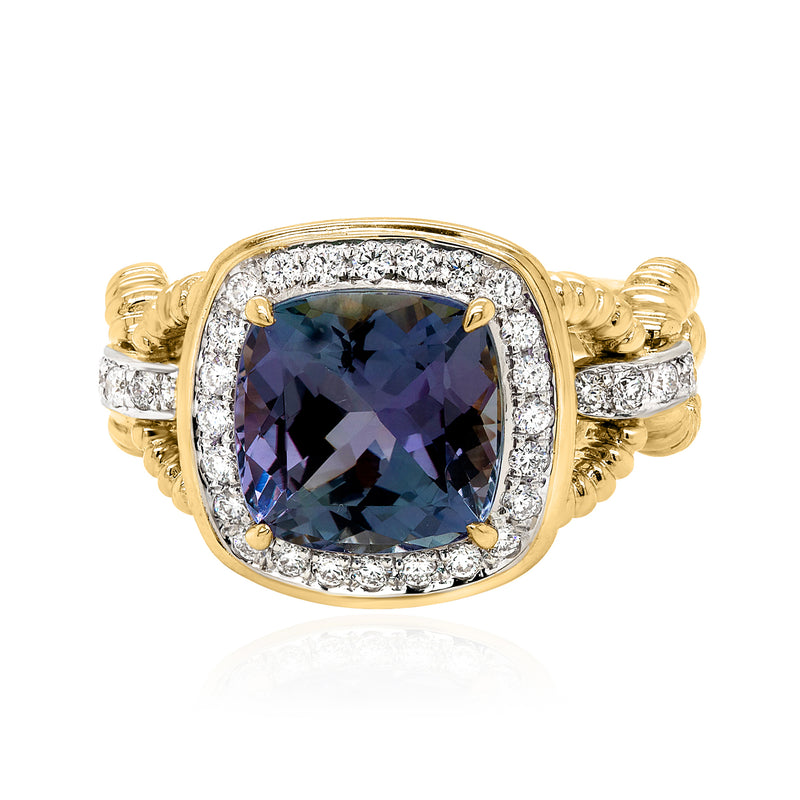 18kt yellow gold tanzanite halo ring with oval gemstone and diamond bezel