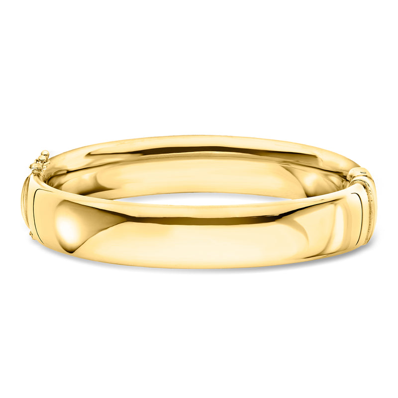 Gold-tone hinged bangle bracelet with polished oval profile