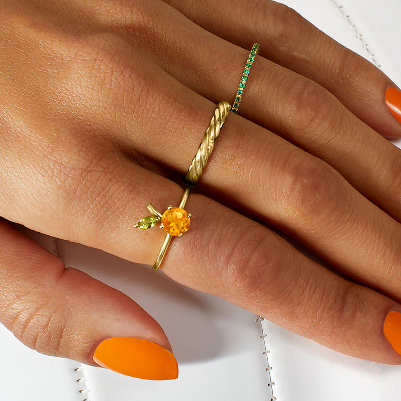 Twisted 14kt yellow gold band ring on finger