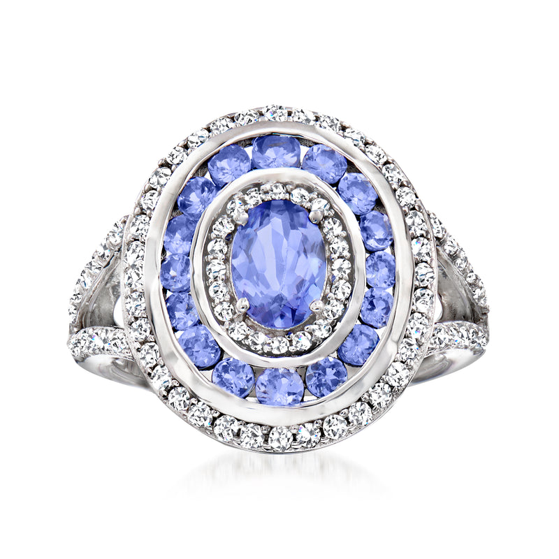 Sterling silver ring with oval blue tanzanite center and round white topaz halo accents