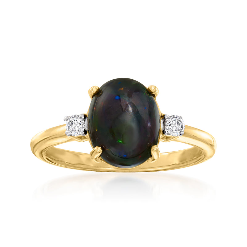 Simulated black opal ring with oval dark center and small white zircon side stones, gold tone