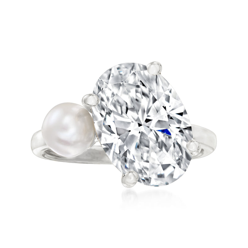 Sterling silver ring with large clear CZ center and white cultured pearl side accents.