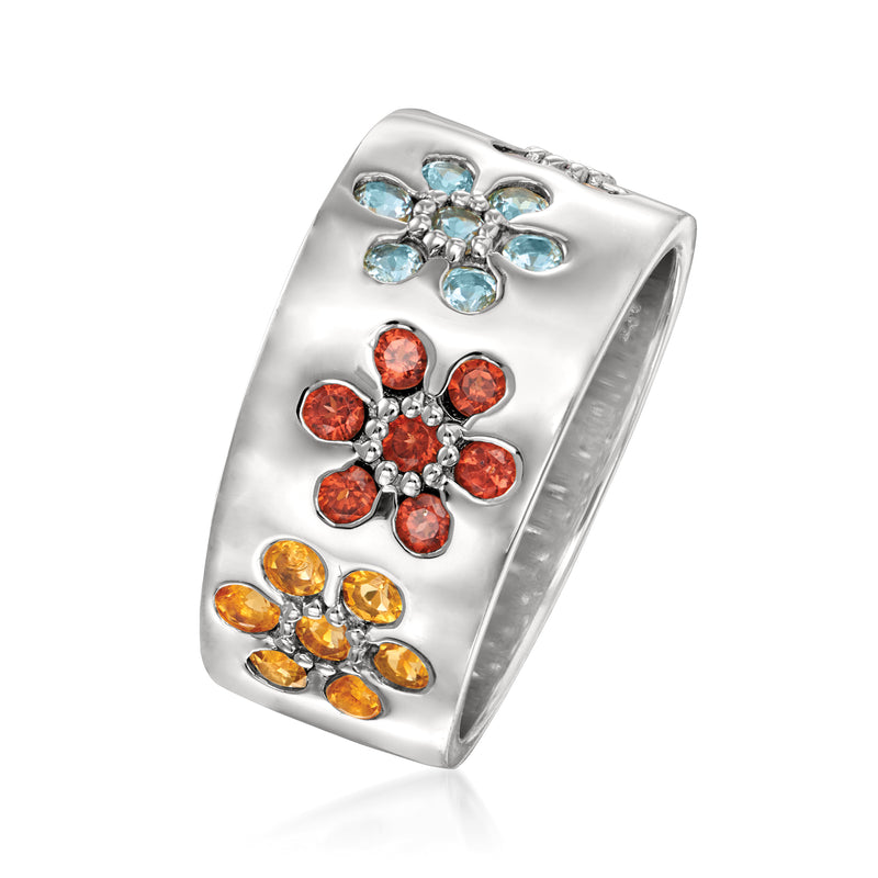Sterling silver multi-gem flower ring, side view with blue, red/orange, and yellow stones