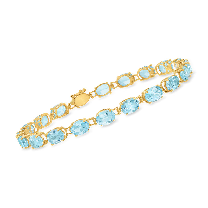 14kt yellow gold tennis bracelet with oval sky blue topaz gemstones