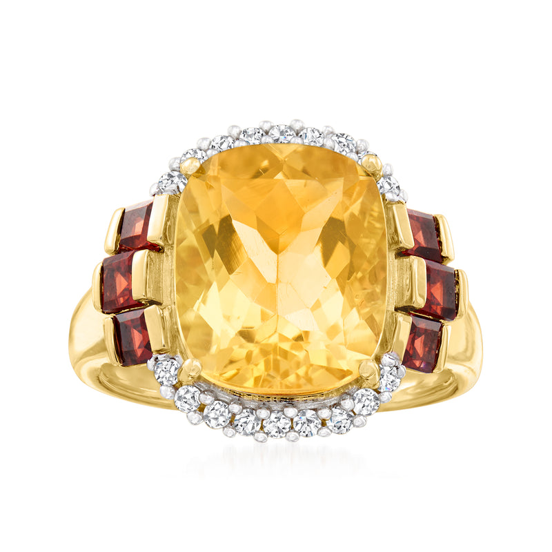 14kt yellow gold ring with oval citrine center, diamond halo and garnet side accents.