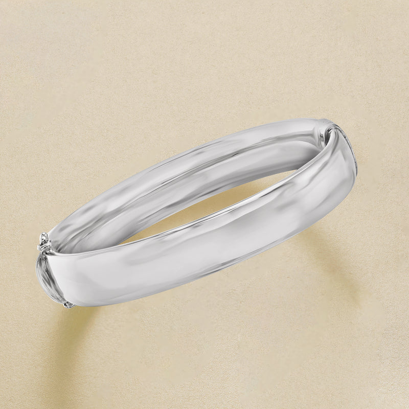 12mm sterling silver bangle bracelet angled view, smooth oval surface with end accents