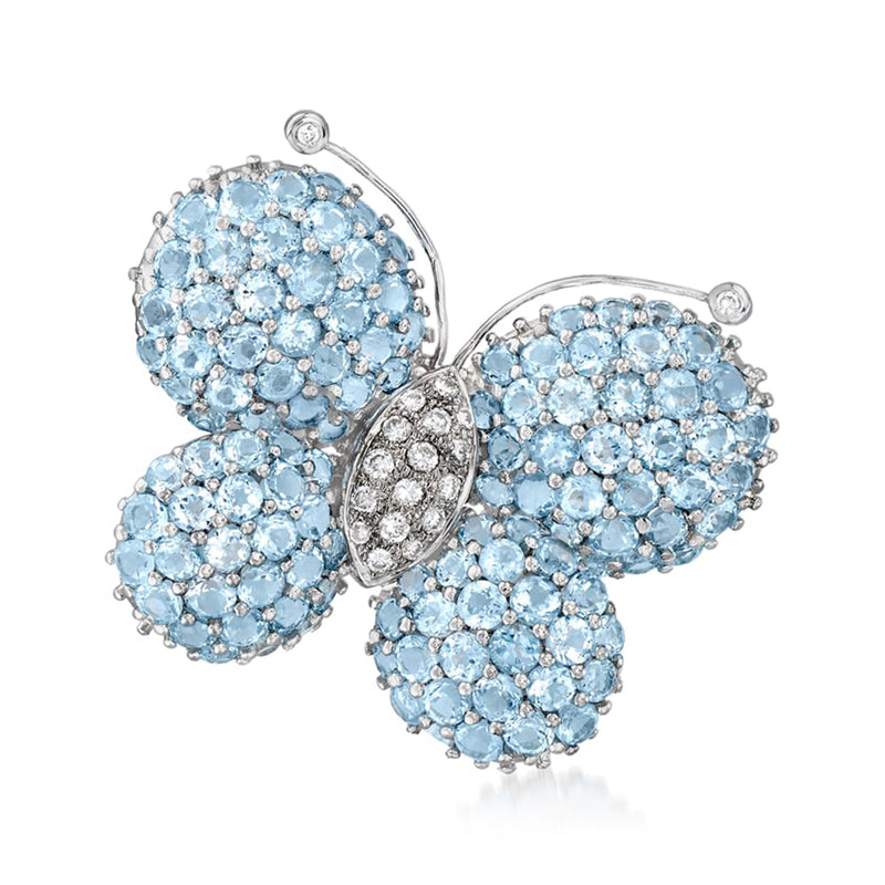 Vintage butterfly pin in silver tone, covered with light blue gemstones and small clear stones