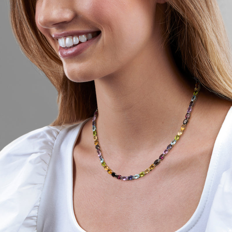 Multicolor gemstone tennis necklace on neckline, small oval stones in silver setting