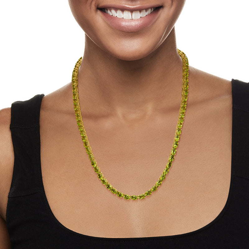 Peridot tennis necklace in 18k gold featuring a row of green gemstones