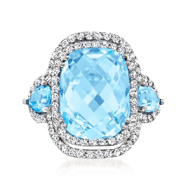 Oval light blue topaz halo diamond ring in 14kt white gold with blue side stones