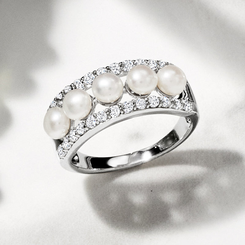 Sterling silver pearl and white gemstone ring, side view with pave settings
