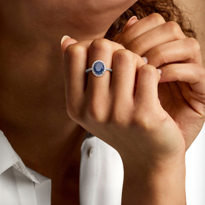 Sapphire and diamond halo ring on hand, 14kt white gold band