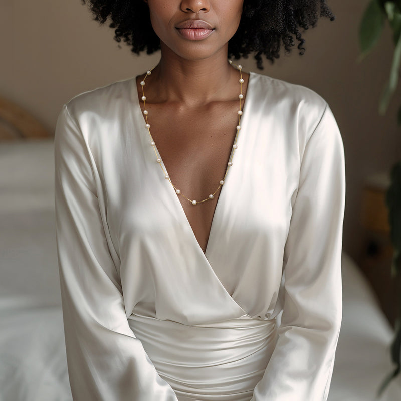 Cultured pearl station necklace in gold over sterling, softly draped on neckline