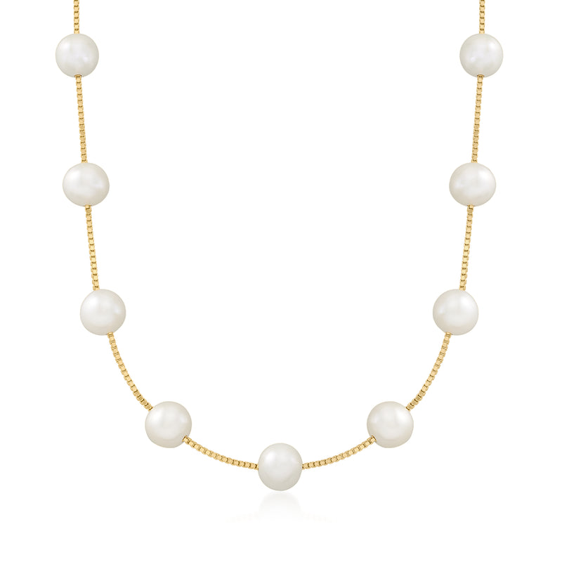 Gold station necklace with five round white pearls on a fine chain
