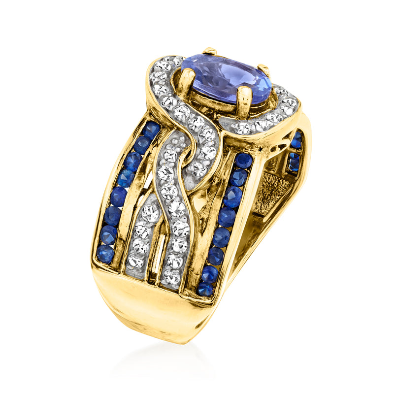Gold-tone side view ring with oval blue center stone, white zircon borders, and blue sapphire rows