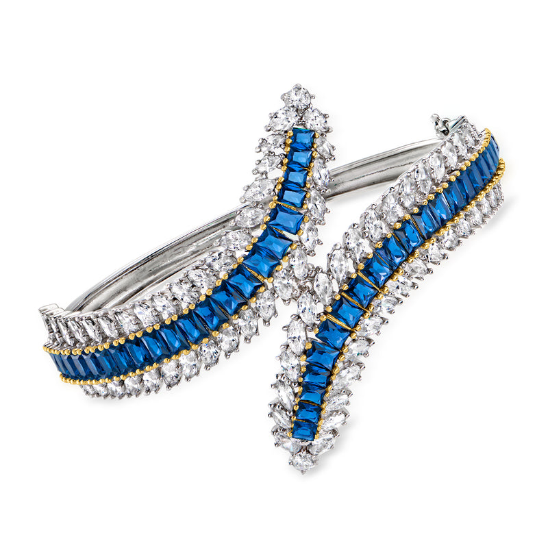 Two-tone sterling silver bypass bangle bracelet with blue and clear baguette-cut stones