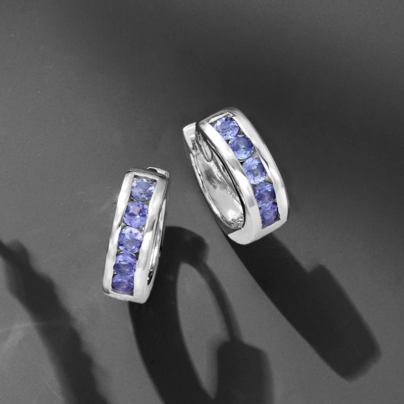 Sterling silver huggie hoop earrings, side view, with three blue-purple gemstone stones