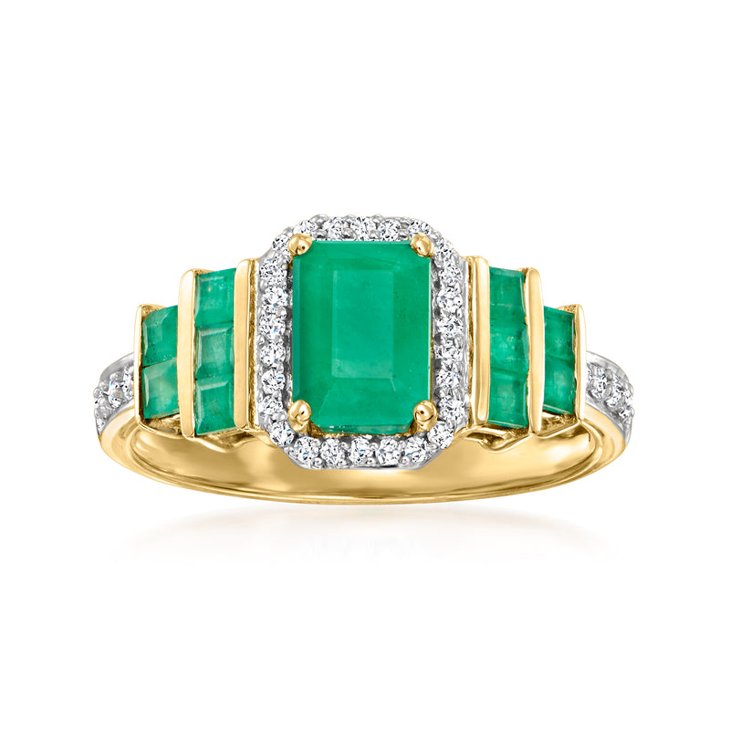 14kt yellow gold ring with emerald center, diamond halo, and emerald side stones